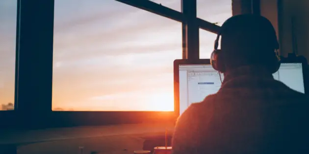 man_sitting_facing_monitor_photo