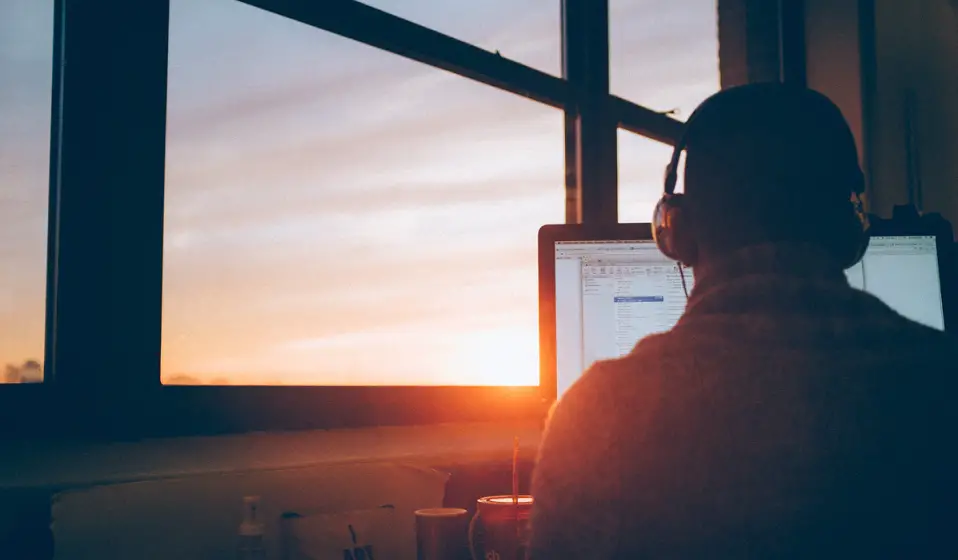 man_sitting_facing_monitor_photo