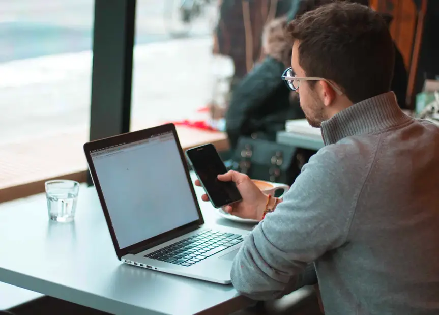 Man with smartphone and computer