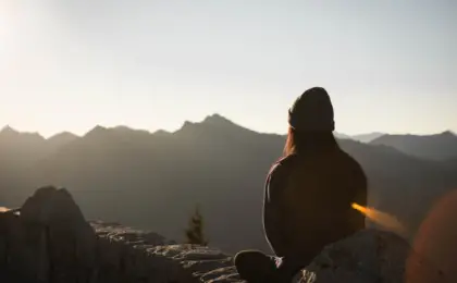 person-wearing-knit-cap-facing-mountain