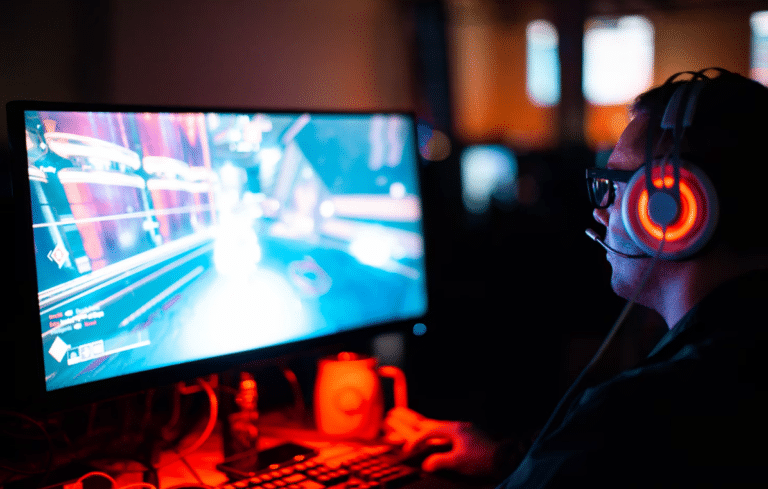 person using computer playing FPS game