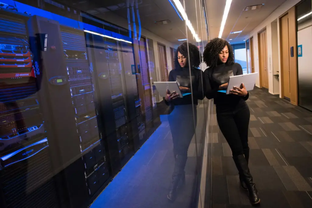 woman using MacBook server room